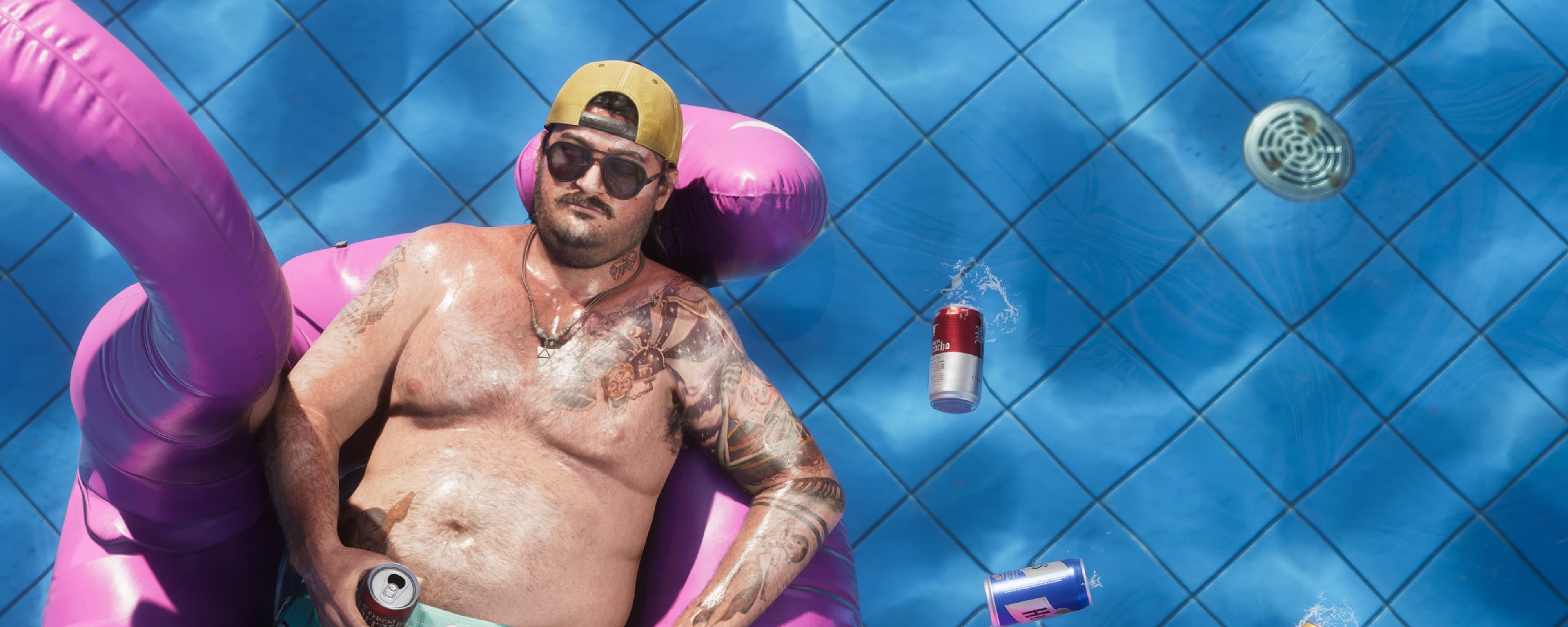 Wide crop of a man asleep on a flamingo pool float surrounded by floating cans