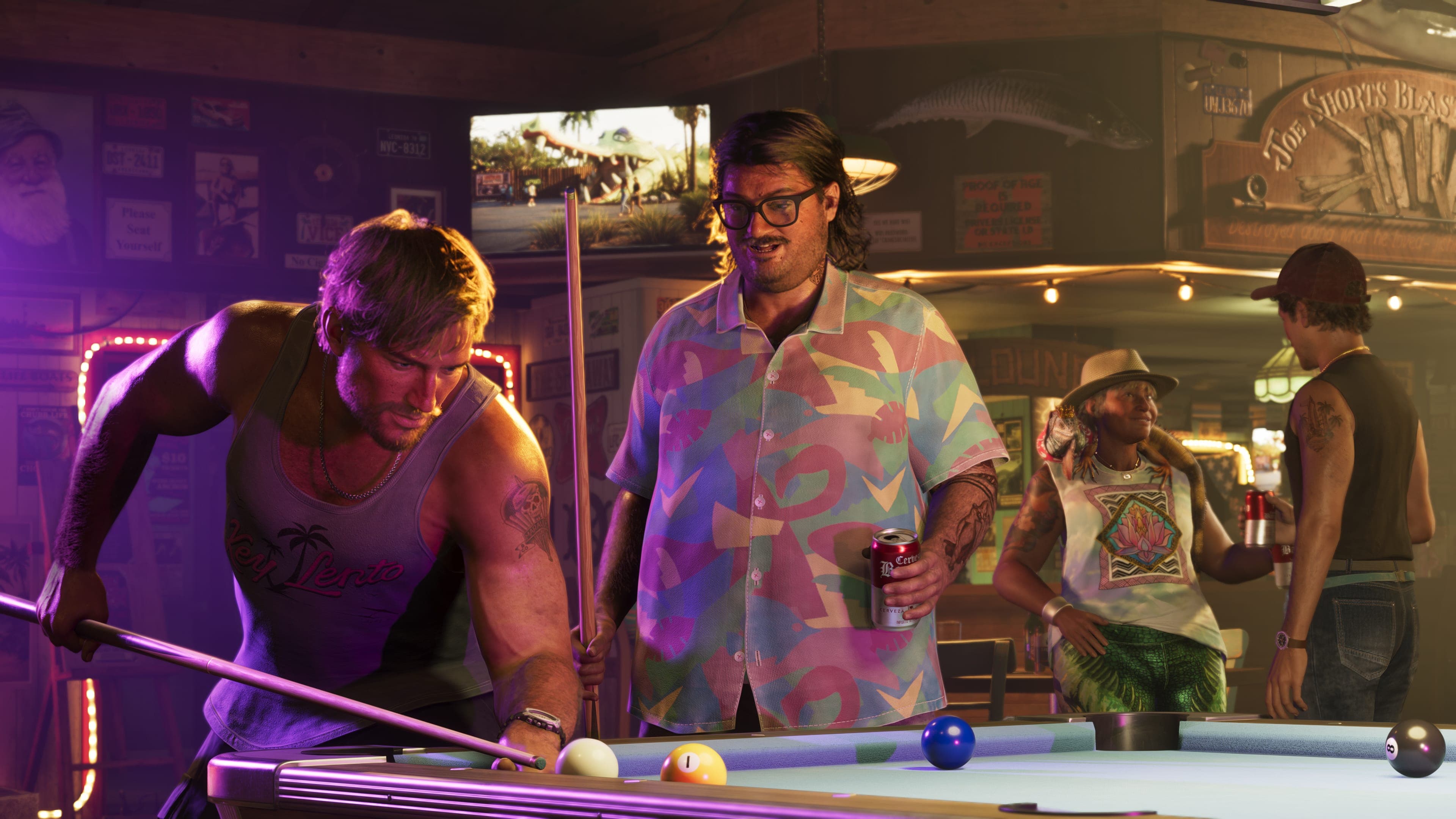 Cal Hampton lining up a shot at a bar pool table while others watch