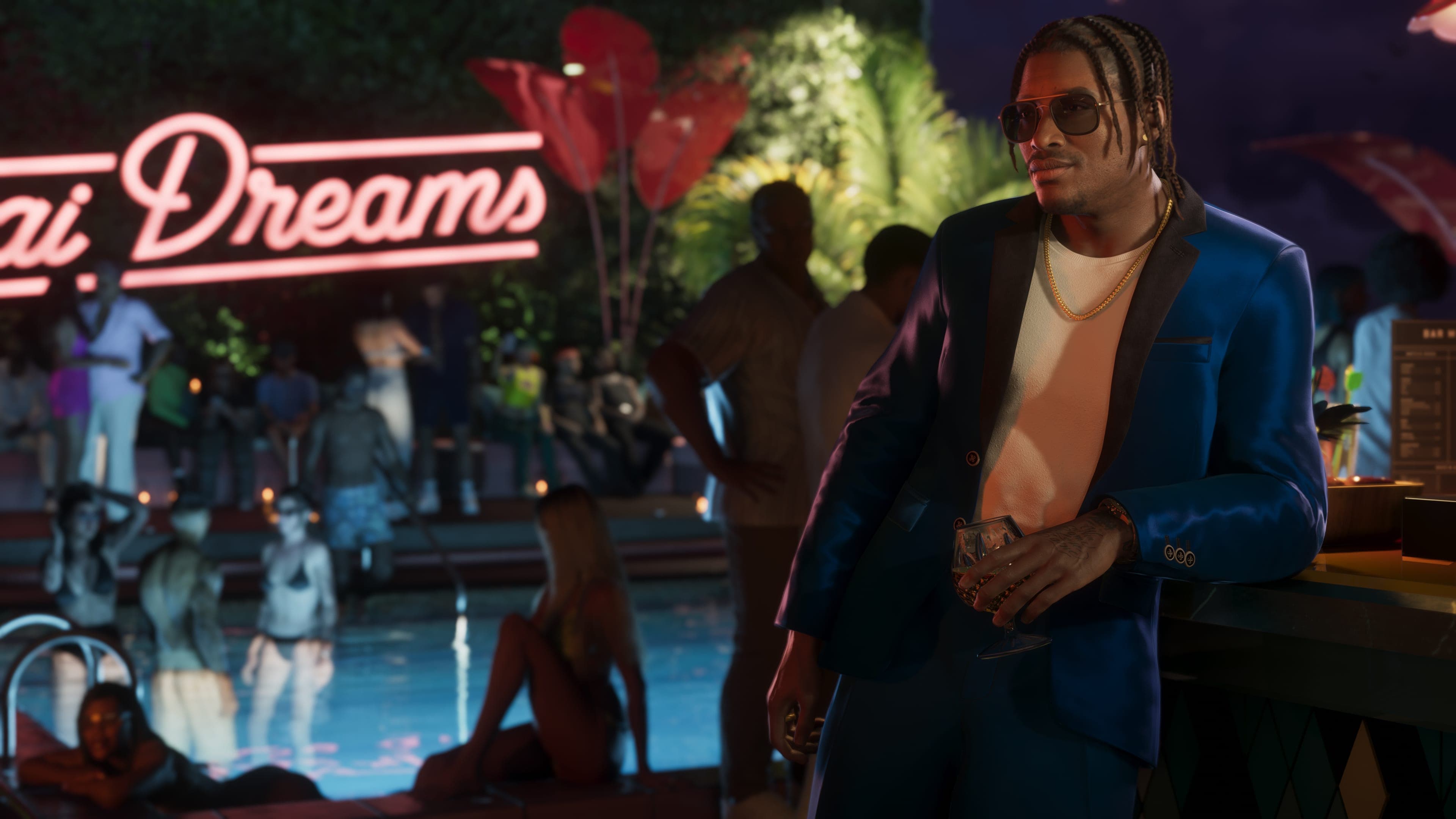 Dre'Quan Priest in a blazer beside a pool below a Miami Dreams neon sign