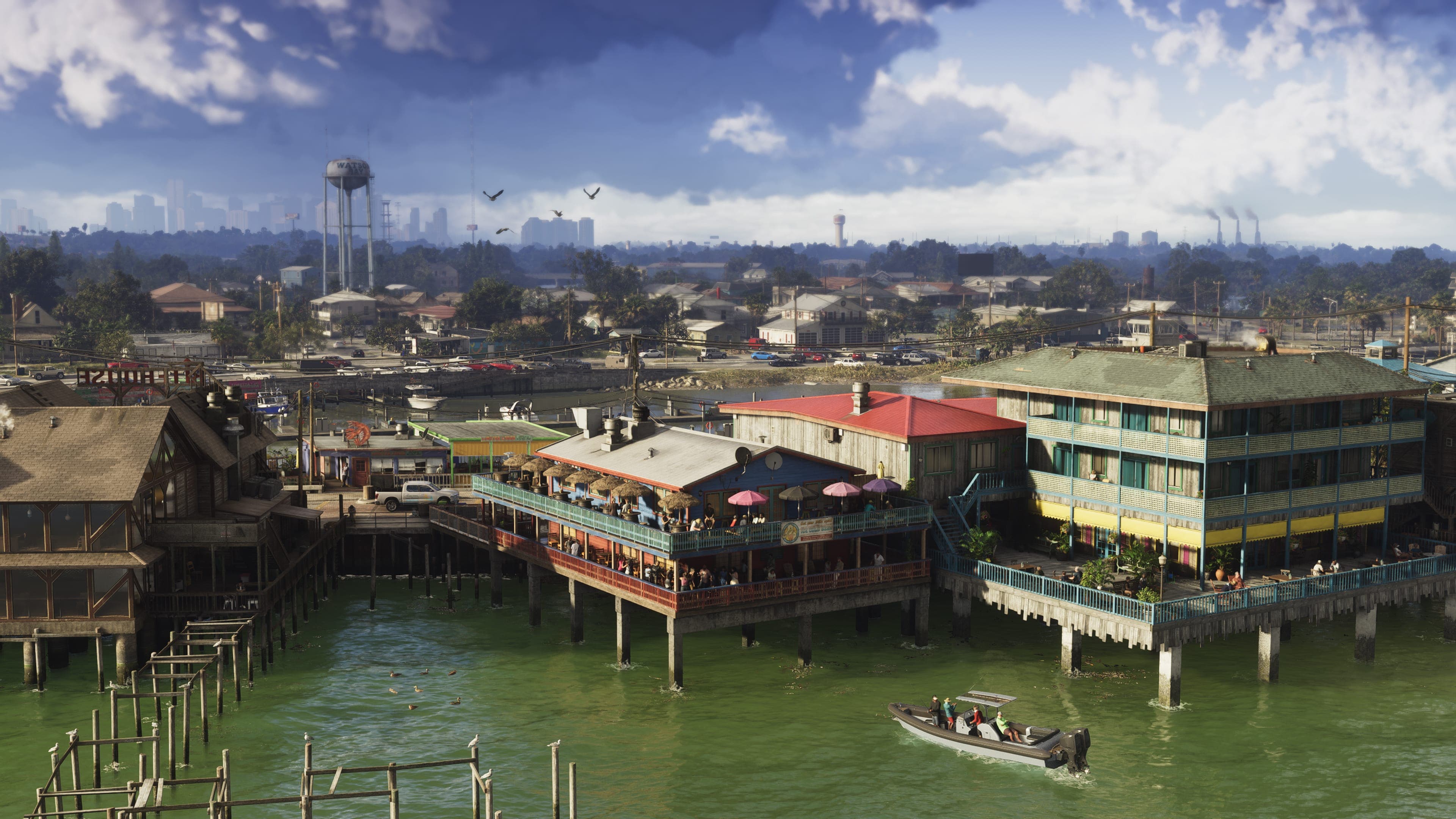 A stilt-house community built out over the water, with the Vice City skyline faint on the horizon