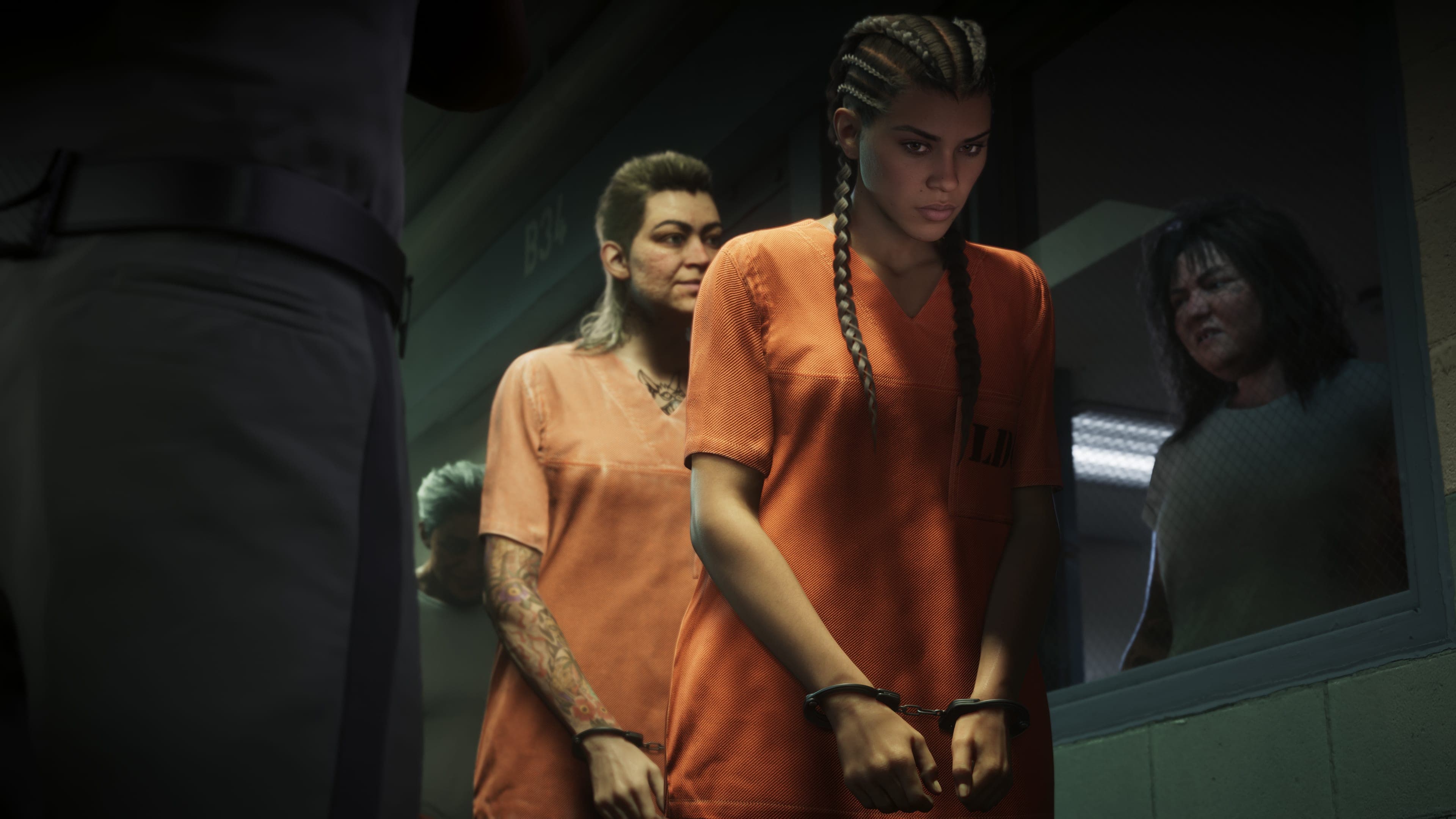Lucia Caminos handcuffed in an orange prison uniform, an officer beside her