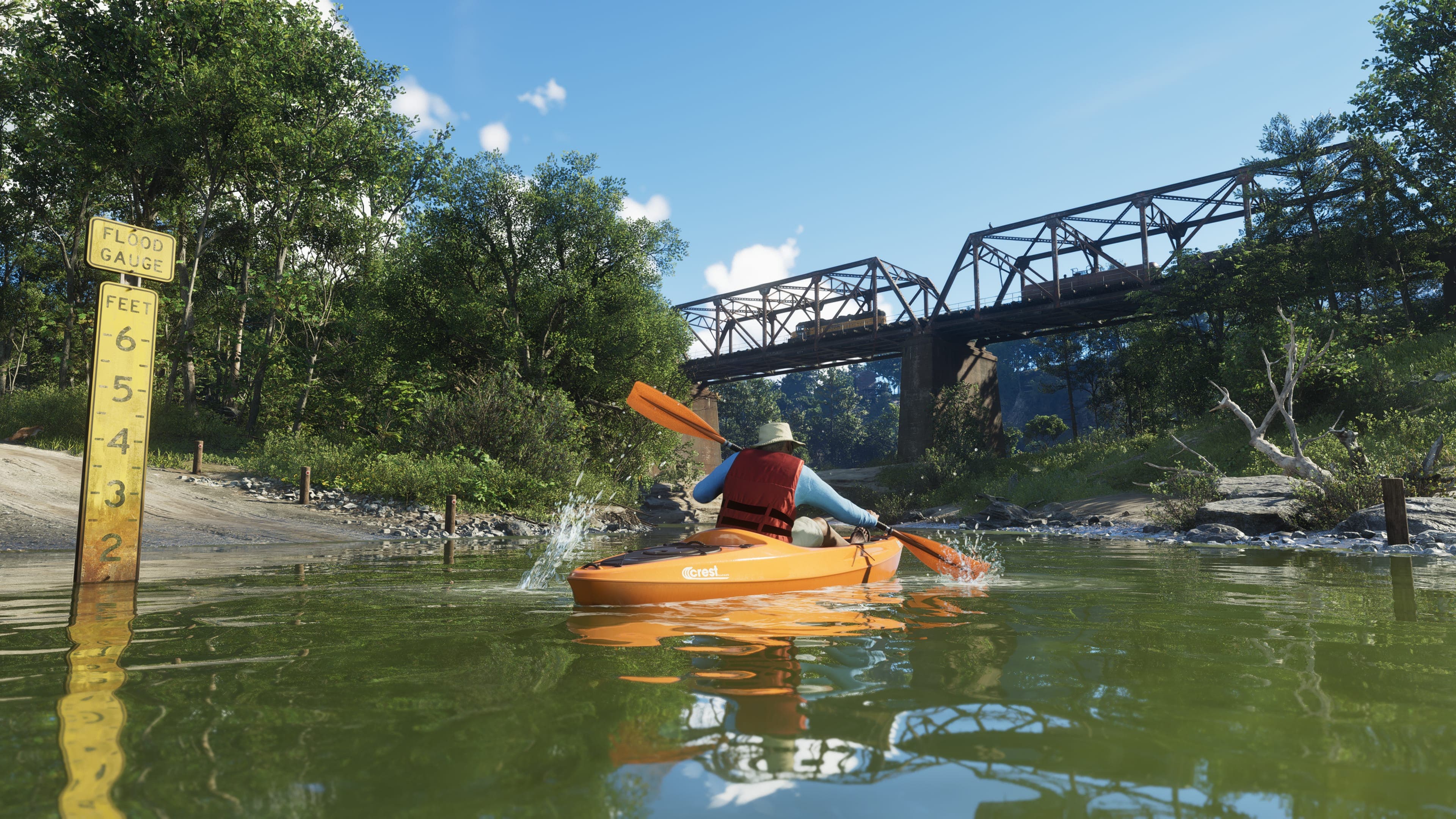A kayaker paddling a yellow kayak under a steel railway bridge