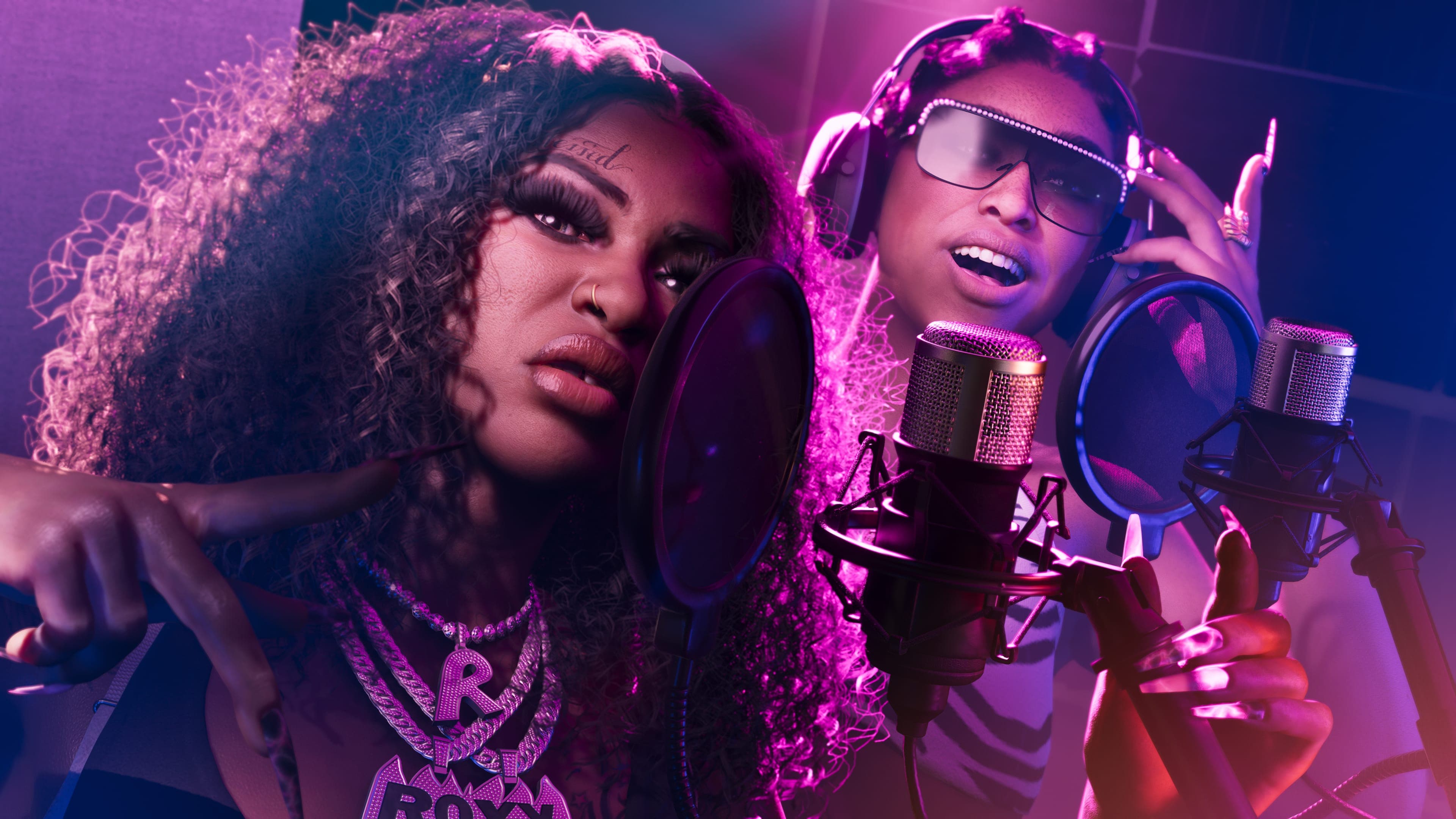 Real Dimez recording together on two microphones under pink and blue light