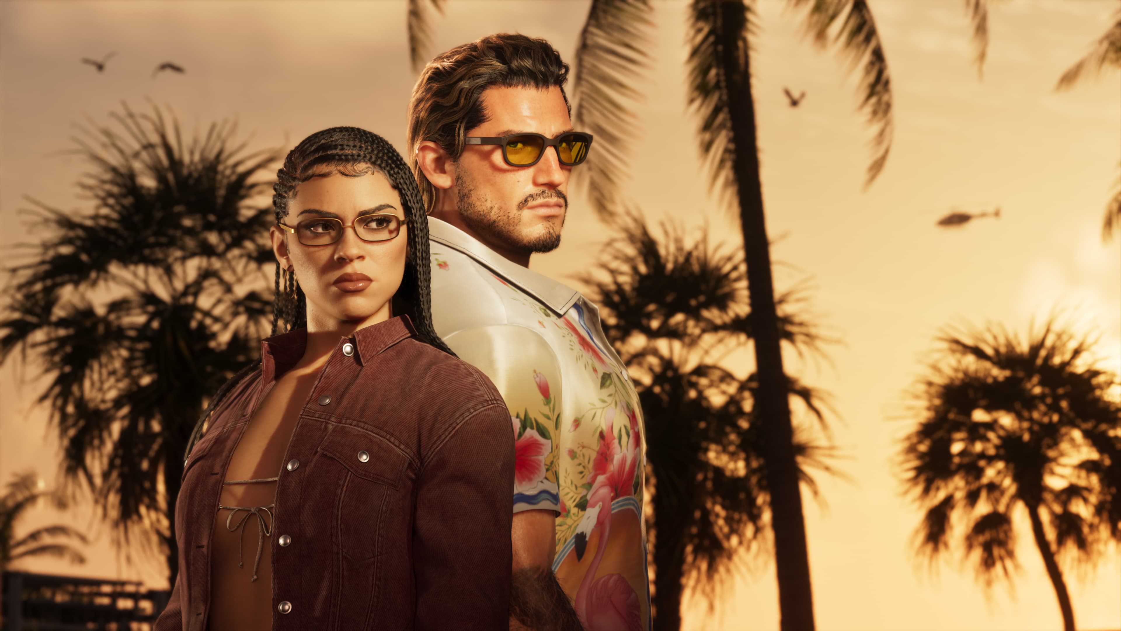 Lucia and Jason in tailored Ultimate Edition outfits standing under palm trees at golden hour