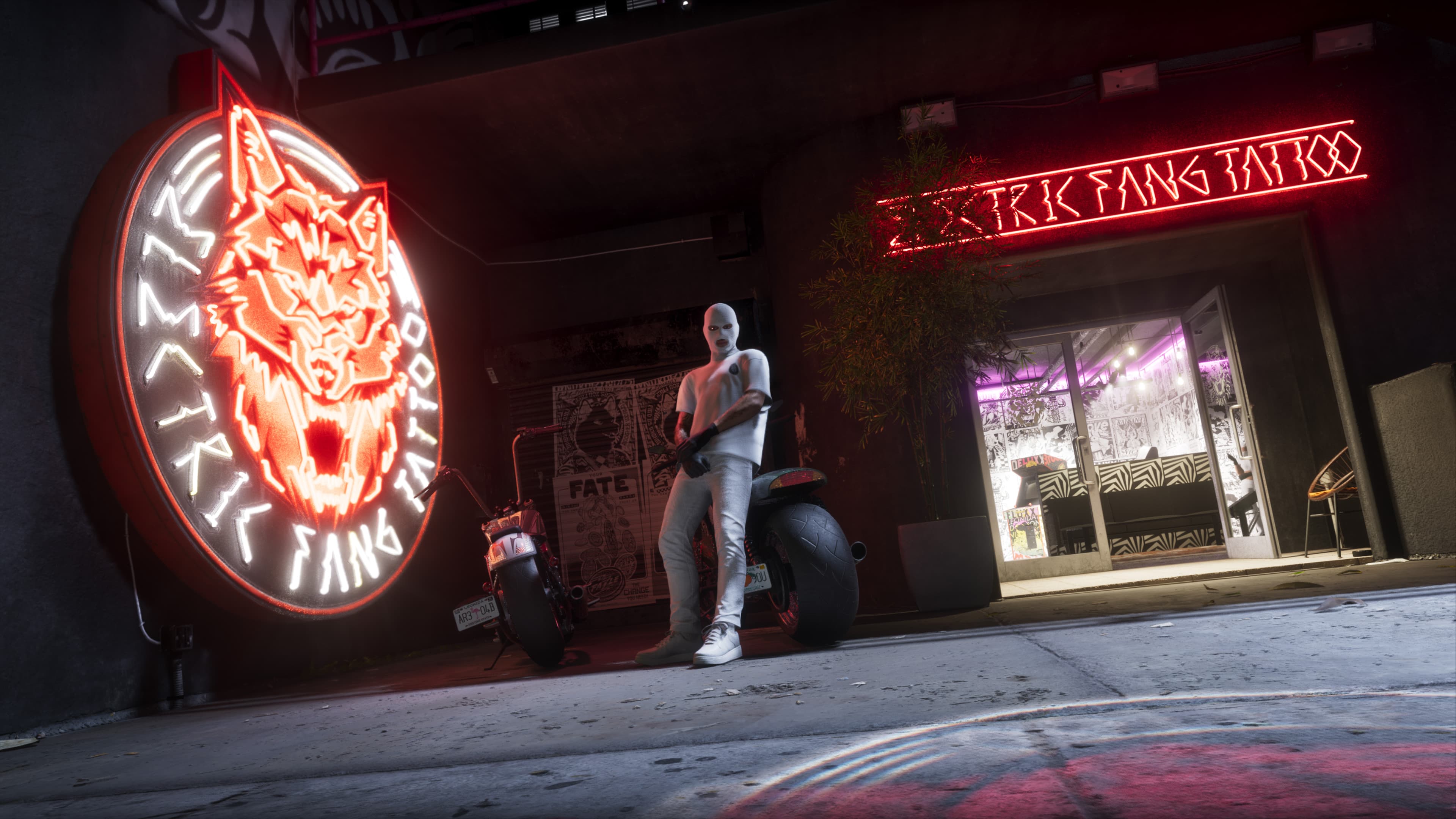 The neon frontage of Electric Fangs Tattoo at night, a motorcycle parked outside