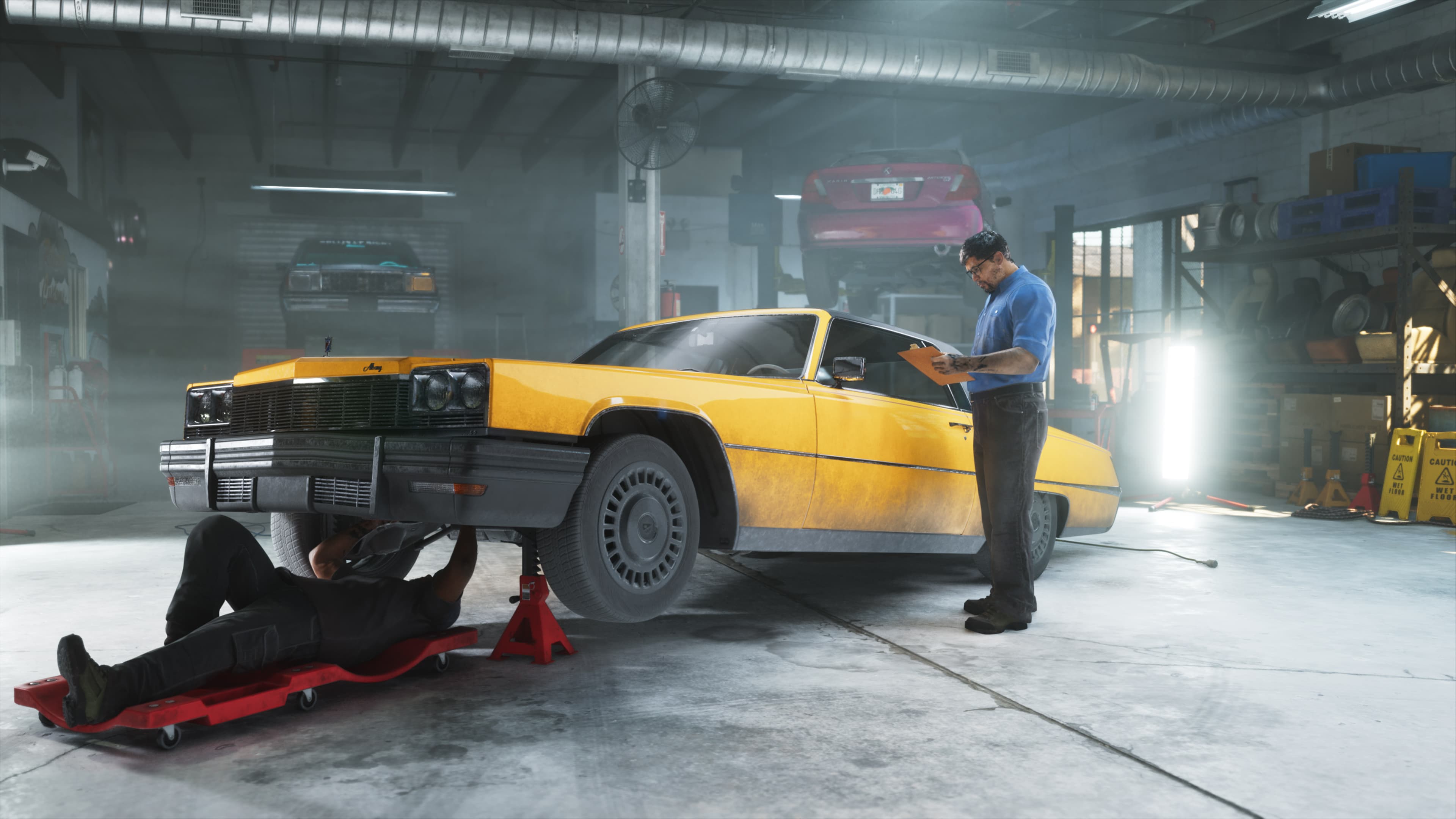 A yellow coupe on a workshop floor with a mechanic underneath and another leaning on the roof