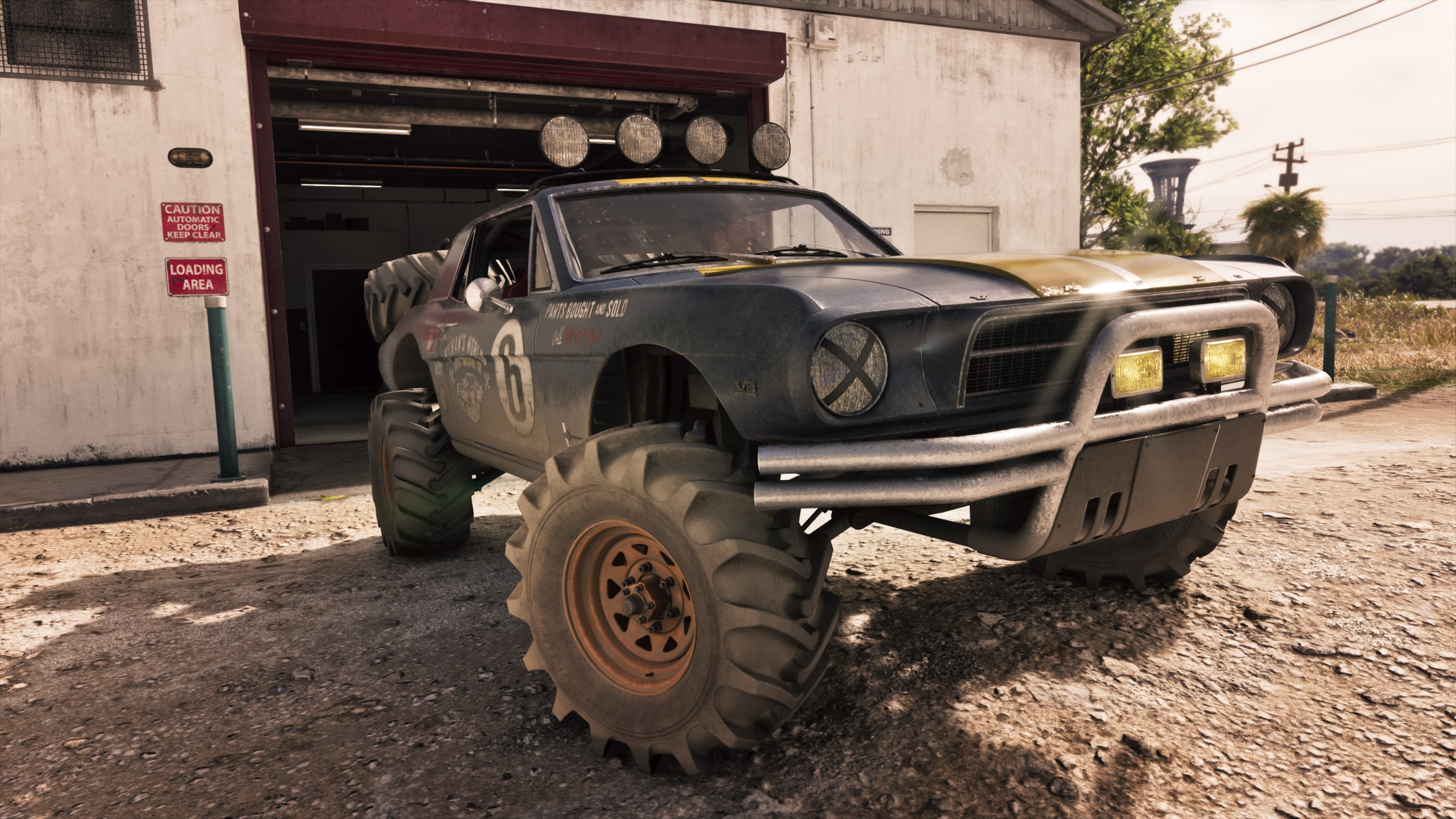 The mud-caked buggy parked on knobbly tyres outside a corrugated garage