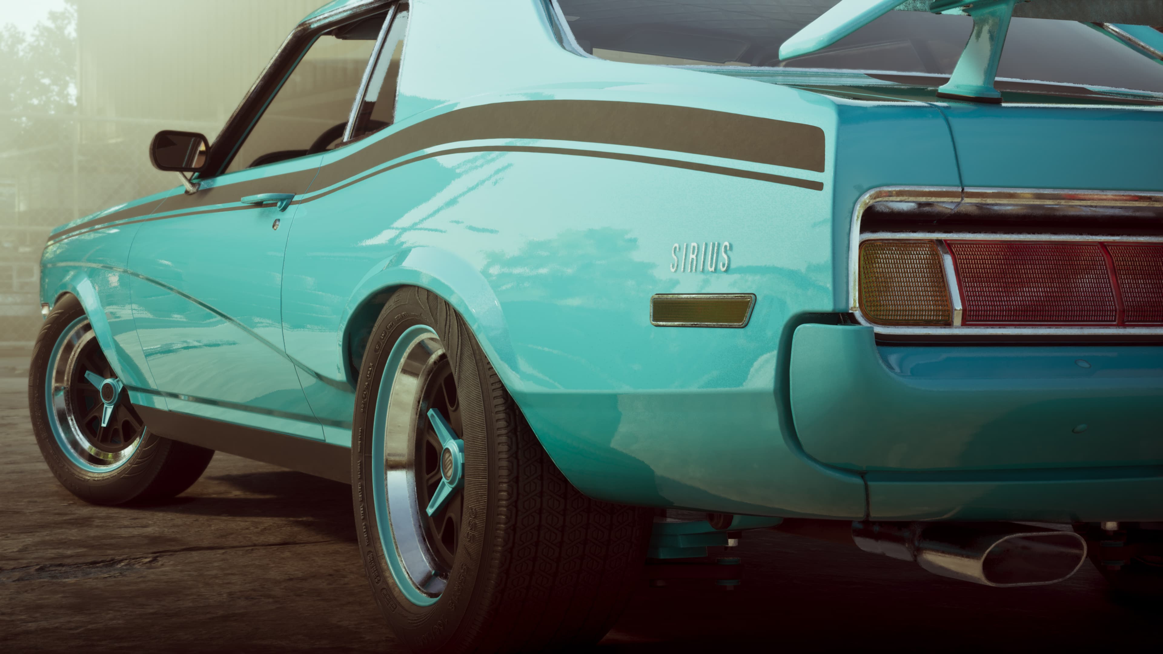 Rear quarter of a teal muscle car with a black vinyl roof