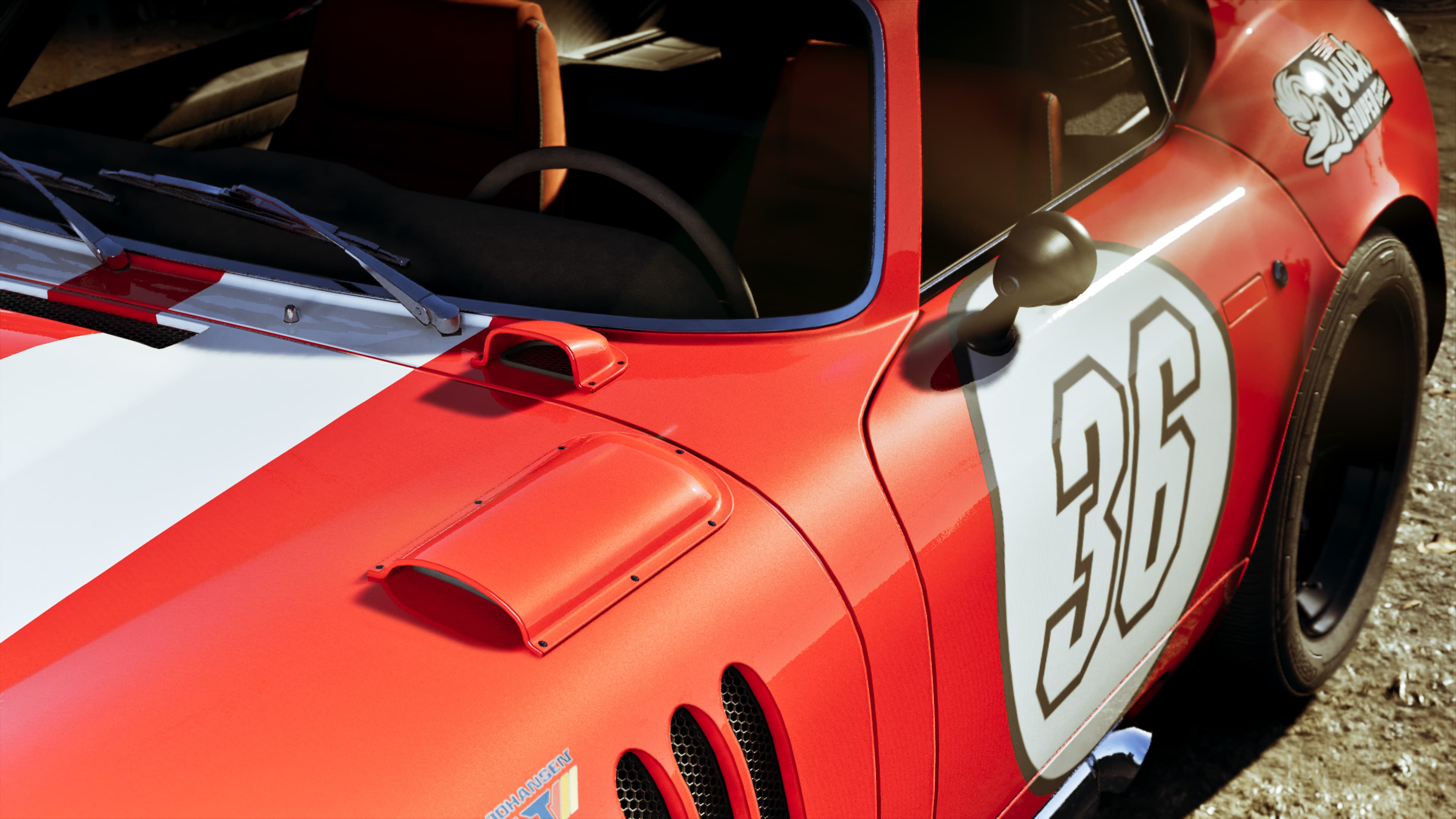 A red race-liveried coupe carrying the number 36 on its door
