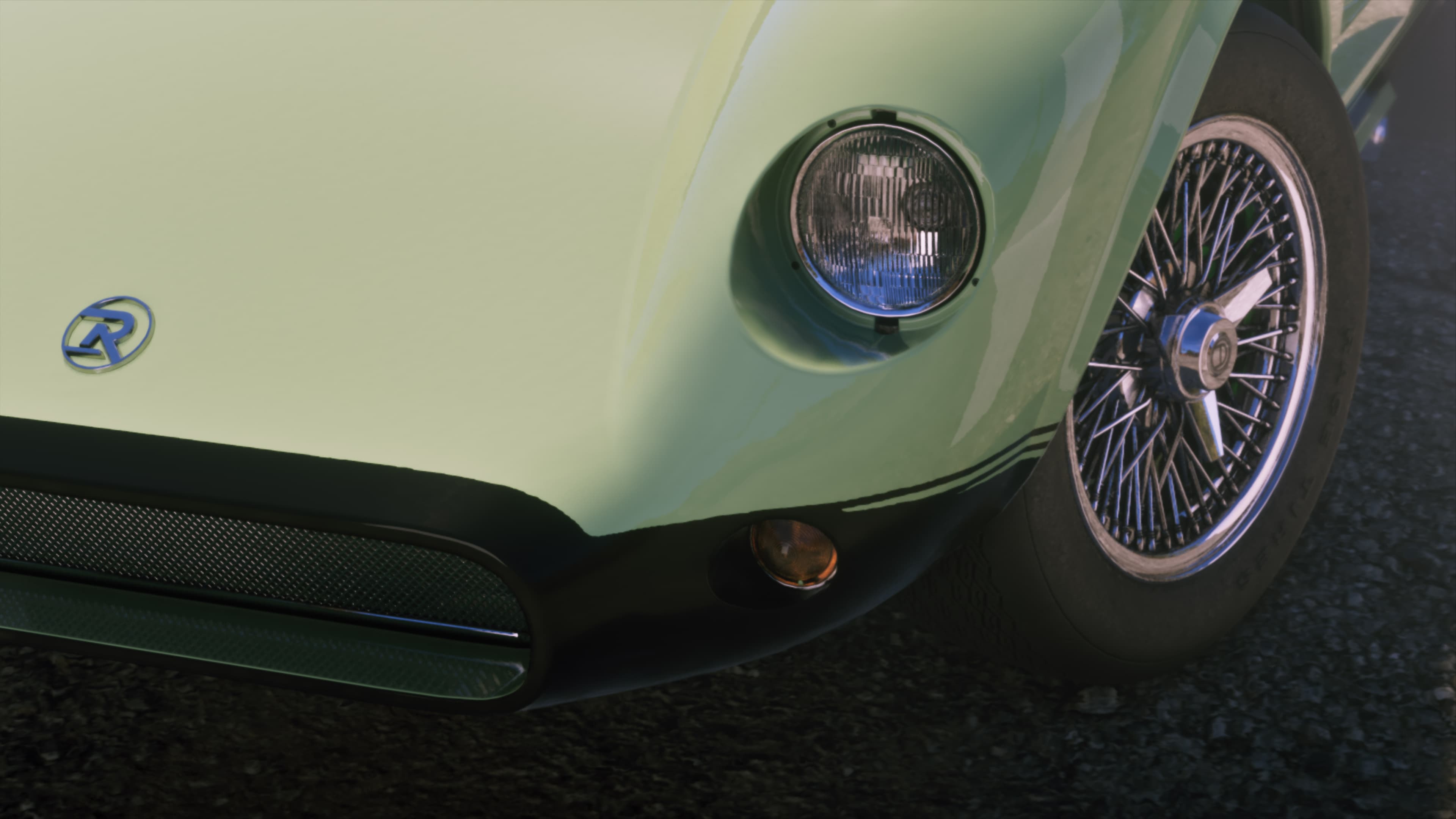 Front detail of a cream classic sports car on wire wheels