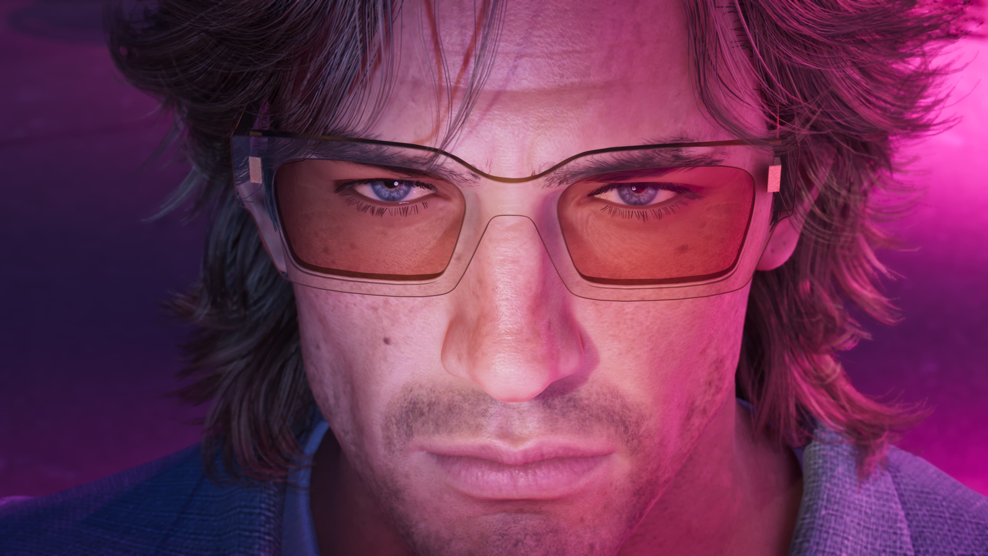 Close portrait of a man in tinted aviator glasses under pink light